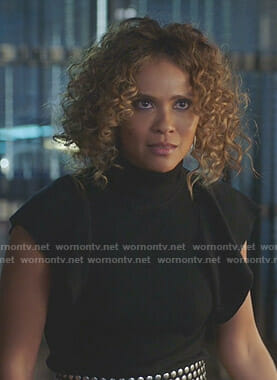 Maze’s black flutter sleeve top and studded wide belt on Lucifer