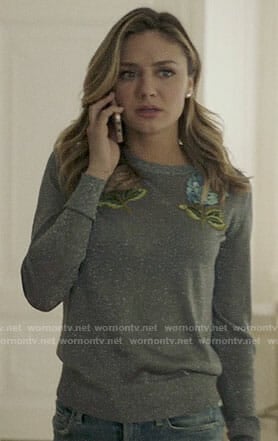 Megan’s metallic sweater with blue flowers on The Arrangement