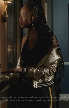 Tangey’s metallic bomber jacket and stripe black pants on Famous in Love