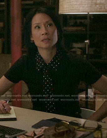 Joan’s black top with polka dot collar and tie on Elementary