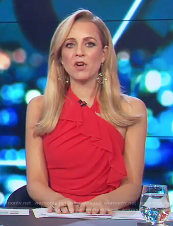 Carrie’s red halter neck ruffle dress on The Project