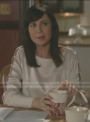 Cassie’s pearl buttoned sleeve top on Good Witch