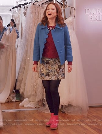 Kimmy’s blue scalloped jacket and cat print skirt on Unbreakable Kimmy Schmidt