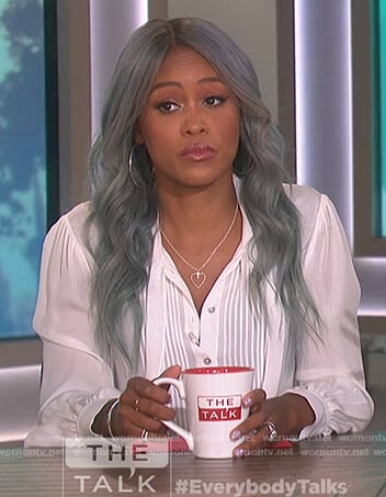 Eve’s white pleated front blouse with tie neck on The Talk