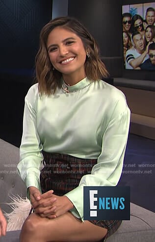Erin’s lime green satin blouse and plaid mini skirt on E! News