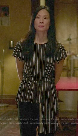 Joan’s striped asymmetric top on Elementary