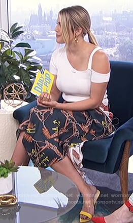 Carissa’s white cutout top and asymmetric print skirt on E! News Daily Pop