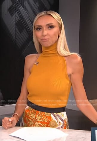 Giuliana’s orange ribbed high neck top and print skirt on E! News