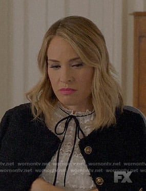 Coco’s white lace top with black tie on American Horror Story Apocalypse