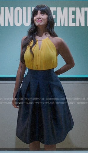 Tahani’s yellow chain detail top and navy pleated skirt on The Good Place
