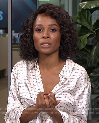 Zuri’s white script print blouse on Live from E!