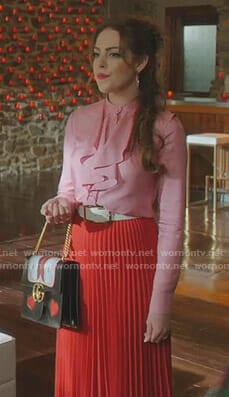 Fallon’s pink ruffled blouse and red pleated skirt on Dynasty