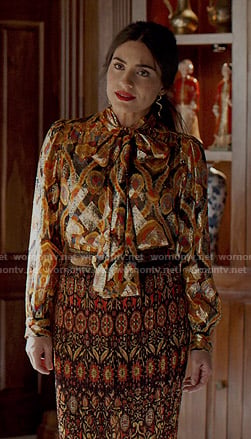 Cristal’s metallic printed tie neck blouse and pleated skirt on Dynasty