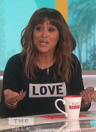 Eve’s black Love print sweater on The Talk