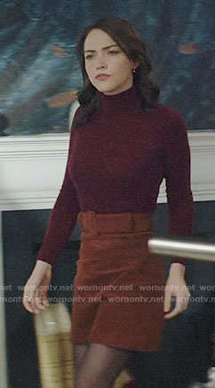 Cara’s burgundy turtleneck and tan skirt on God Friended Me
