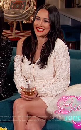 Brie Bella’s off-white one-shoulder dress on Busy Phillips