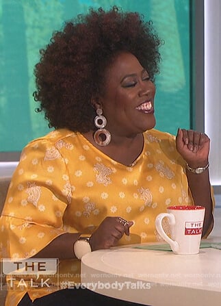 Sheryl’s yellow printed ruffle sleeve top on The Talk