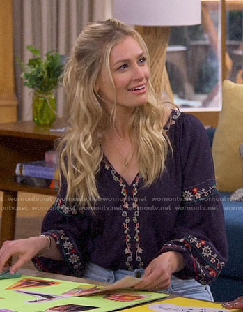 Gemma’s navy embroidered peasant top on The Neighborhood