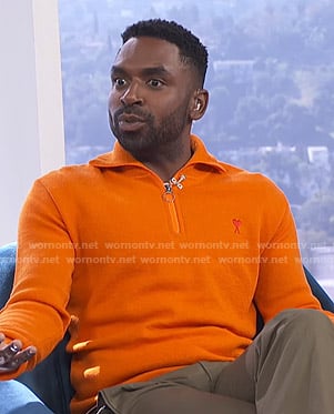 Justin’s orange half-zip sweater on E! News Daily Pop