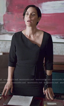 Jeryn’s navy asymmetric sheath dress on Jessica Jones