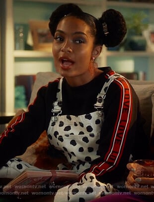 Zoe’s white overalls and love sweatshirt on Grown-ish