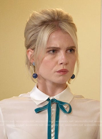 Astrid’s white blouse and blue studded skirt on The Politician
