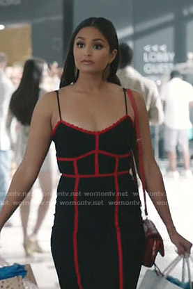 Carolina’s black dress with red trim on Grand Hotel