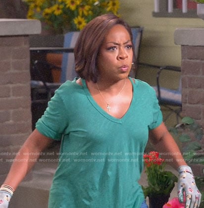 Tina’s green v-neck tee with cutouts on The Neighborhood