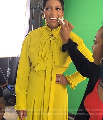Tamron’s yellow ruffled blouse and skirt on Tamron Hall Show