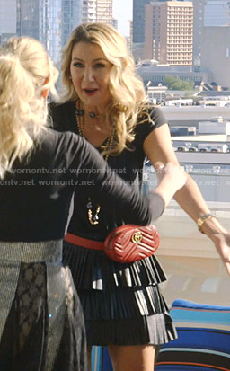 Kary’s leather pleated mini skirt and red belt bag on The Real Housewives of Dallas