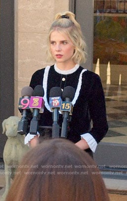Astrid’s black velvet dress with white ruffles on The Politician