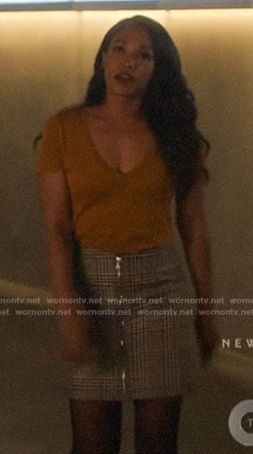 Iris’s yellow v-neck tee and plaid zip front skirt on The Flash