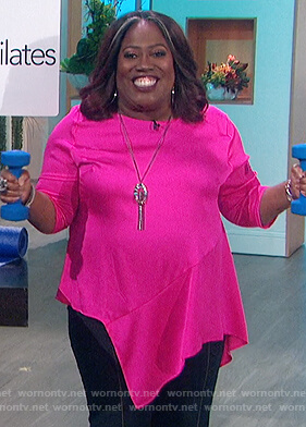Sheryl’s pink asymmetric top on The Talk