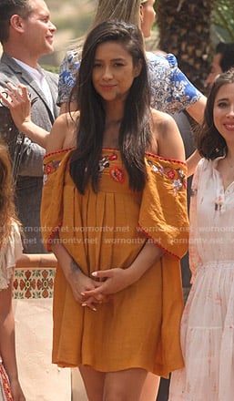 Stella’s orange embroidered off-shoulder dress on Dollface