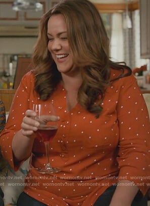 Katie’s orange printed blouse on American Housewife