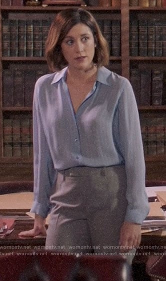 Sydney’s blue striped button down blouse and grey trousers on Bluff City Law