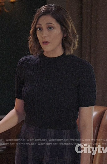 Sydney’s black cable knit top and plaid trousers on Bluff City Law