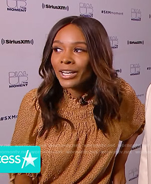 Zuri’s beige polka dot smocked blouse on Access Hollywood