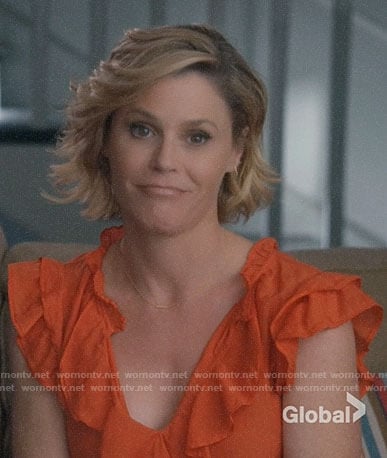 Claire’s orange ruffled top on Modern Family