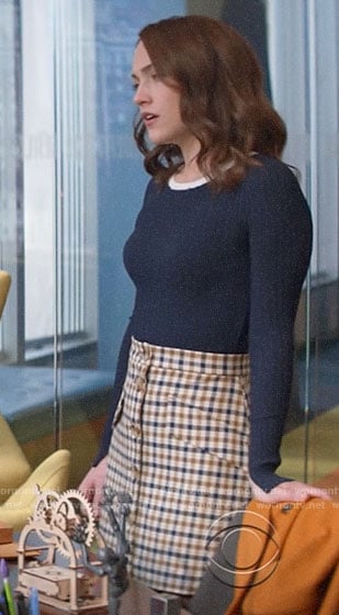 Cara’s navy ribbed sweater and checked button front skirt on God Friended Me