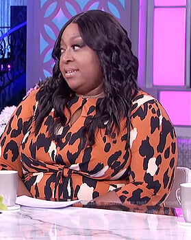 Loni’s orange twisted leopard dress on The Real