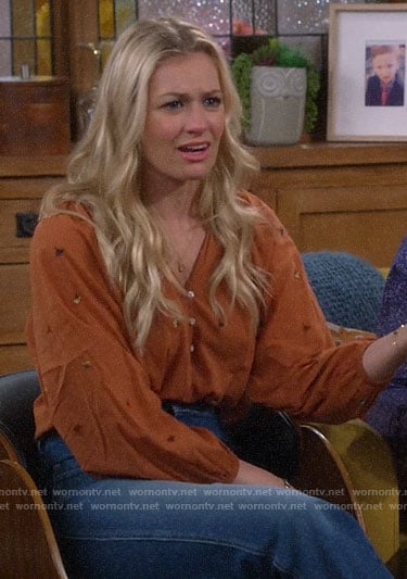 Gemma’s orange floral embroidered top on The Neighborhood