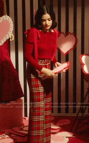 Katy’s red tie shoulder sweater and plaid pants on Katy Keene