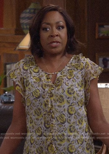 Tina’s floral ruffled top on The Neighborhood