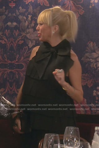 Sutton’s black bow-embellished pleated dress on The Real Housewives of Beverly Hills