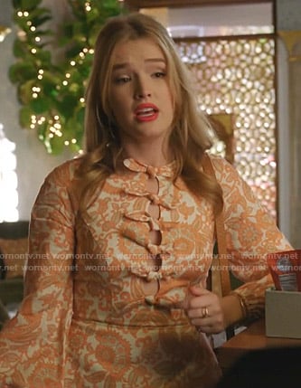 Kirby’s orange paisley print cutout dress on Dynasty