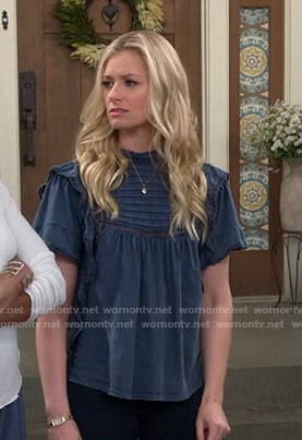Gemma’s blue ruffle top on The Neighborhood