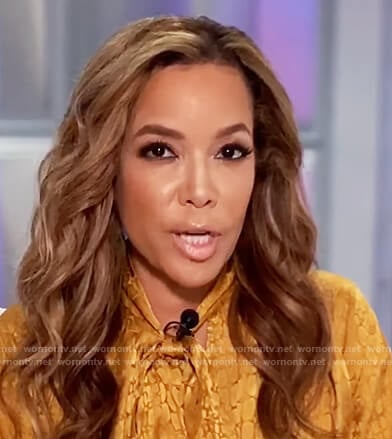 Sunny’s gold jacquard tie neck blouse on The View