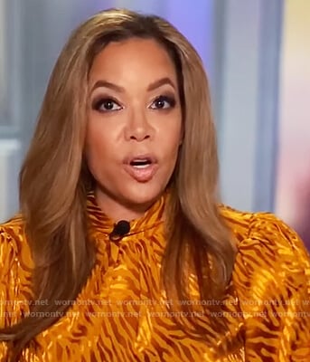 Sunny’s orange metallic blouse on The View