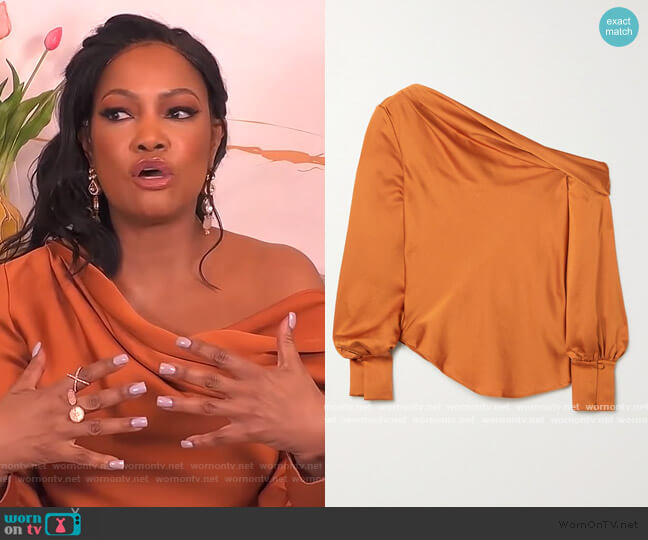 Jonathan Simkhai Alice draped one-shoulder satin blouse worn by Garcelle Beauvais on The Real